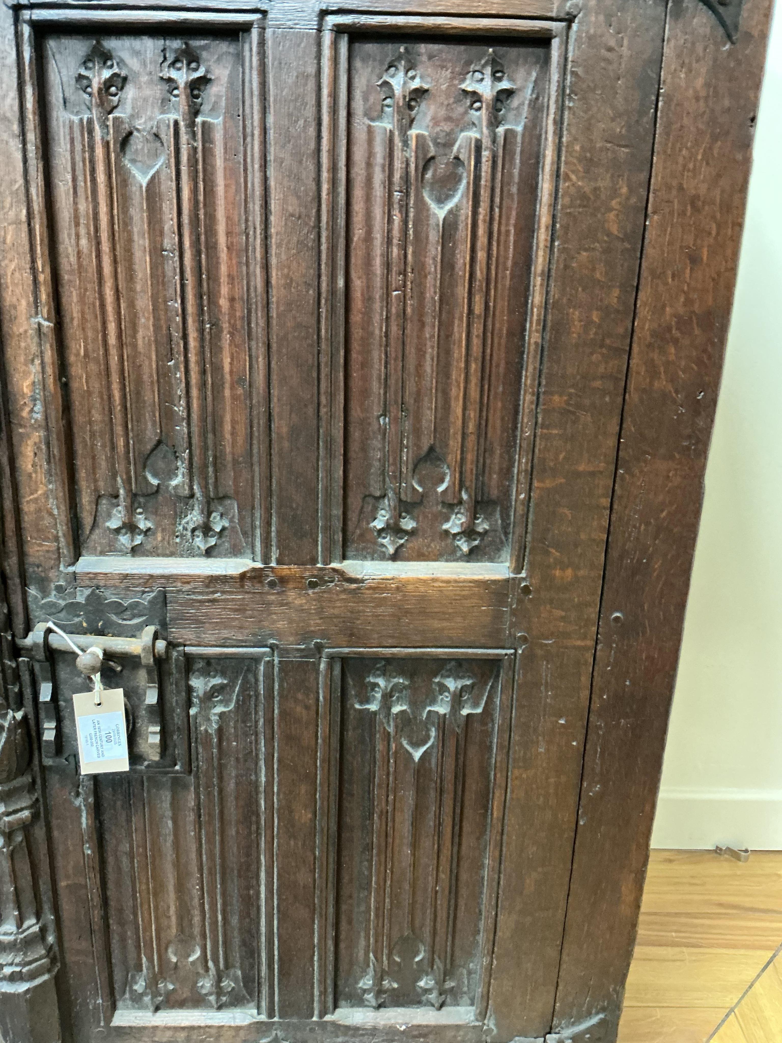 An 18th century and later French carved oak two door cabinet, width 115cm, depth 53cm, height 115cm